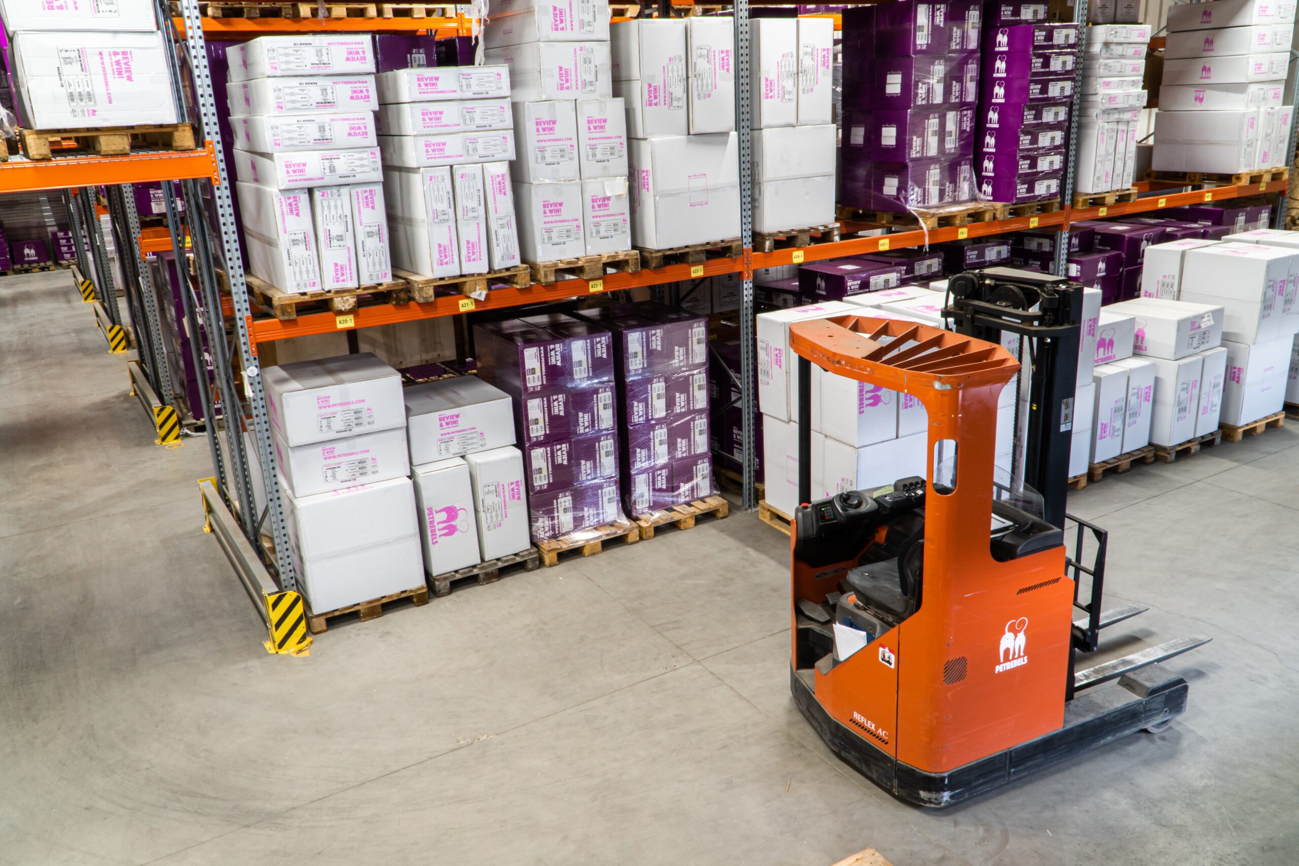 alt="forklift operating in distribution warehouse"